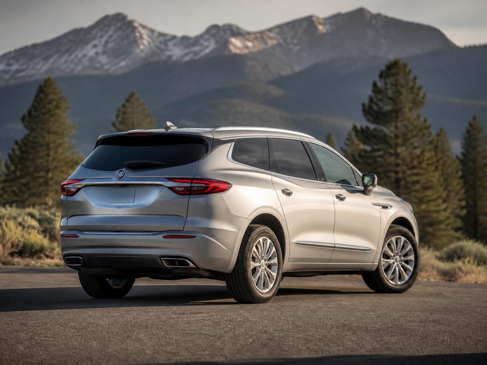 Silver Buick Enclave parked on a Central Oregon road with mountains behind it